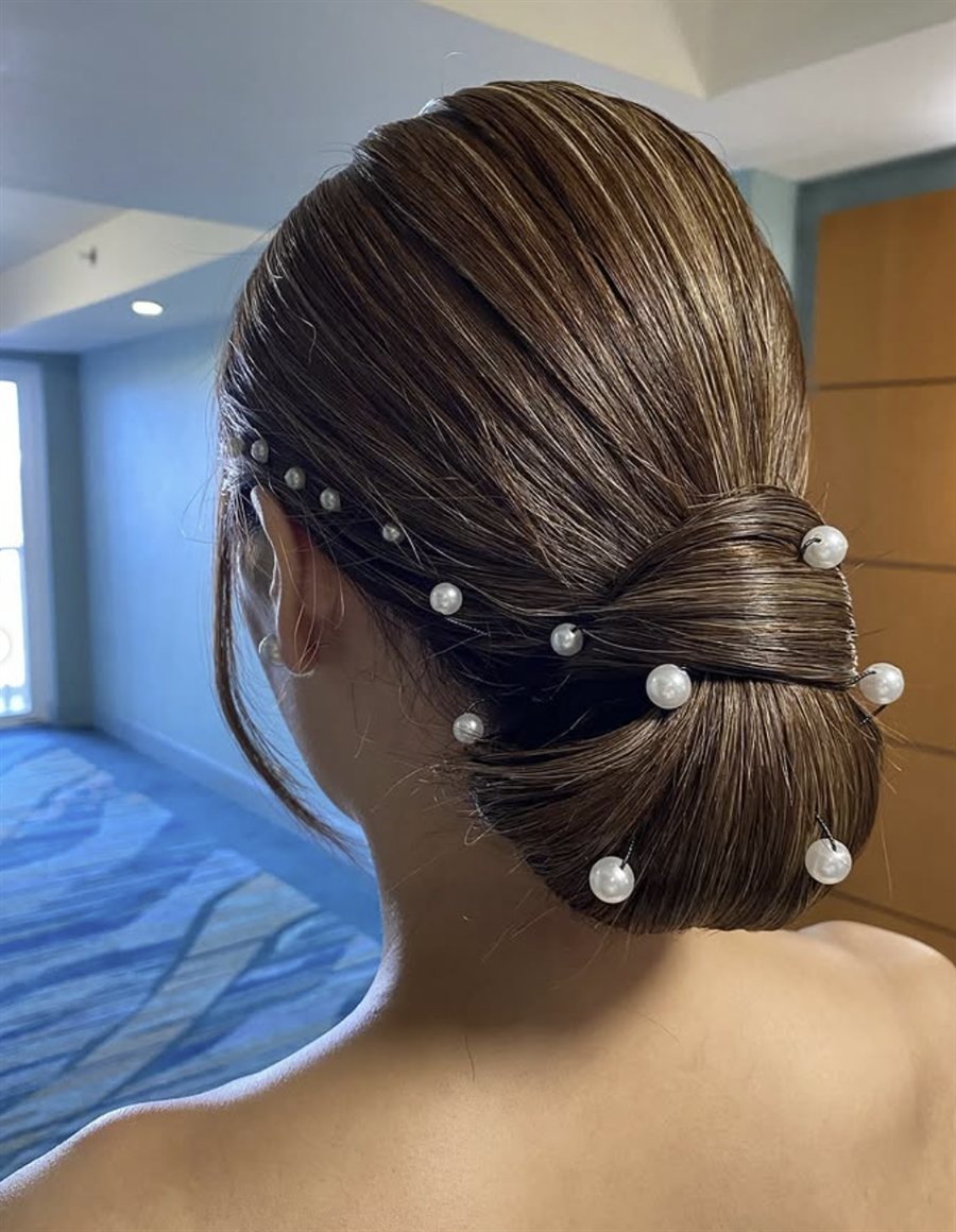 Sleek low bun with cascading pearl pins